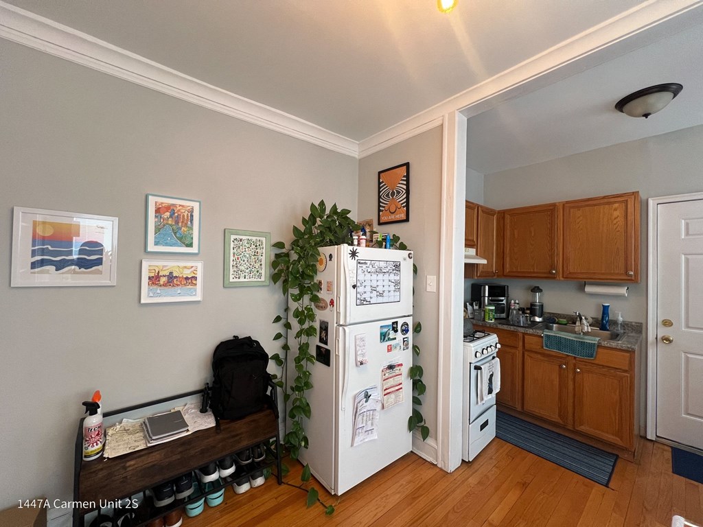 a kitchen with a refrigerator and a stove and a sink