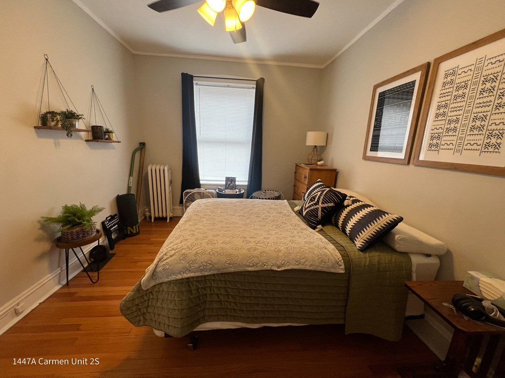 a bedroom with a bed and a ceiling fan