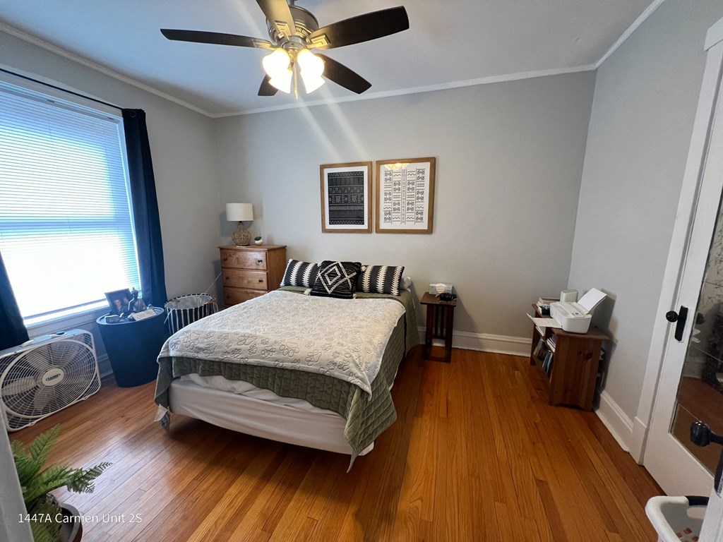 a bedroom with a bed and a ceiling fan