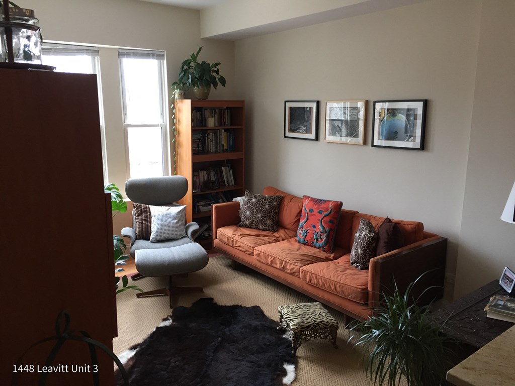 a living room with a couch and a chair