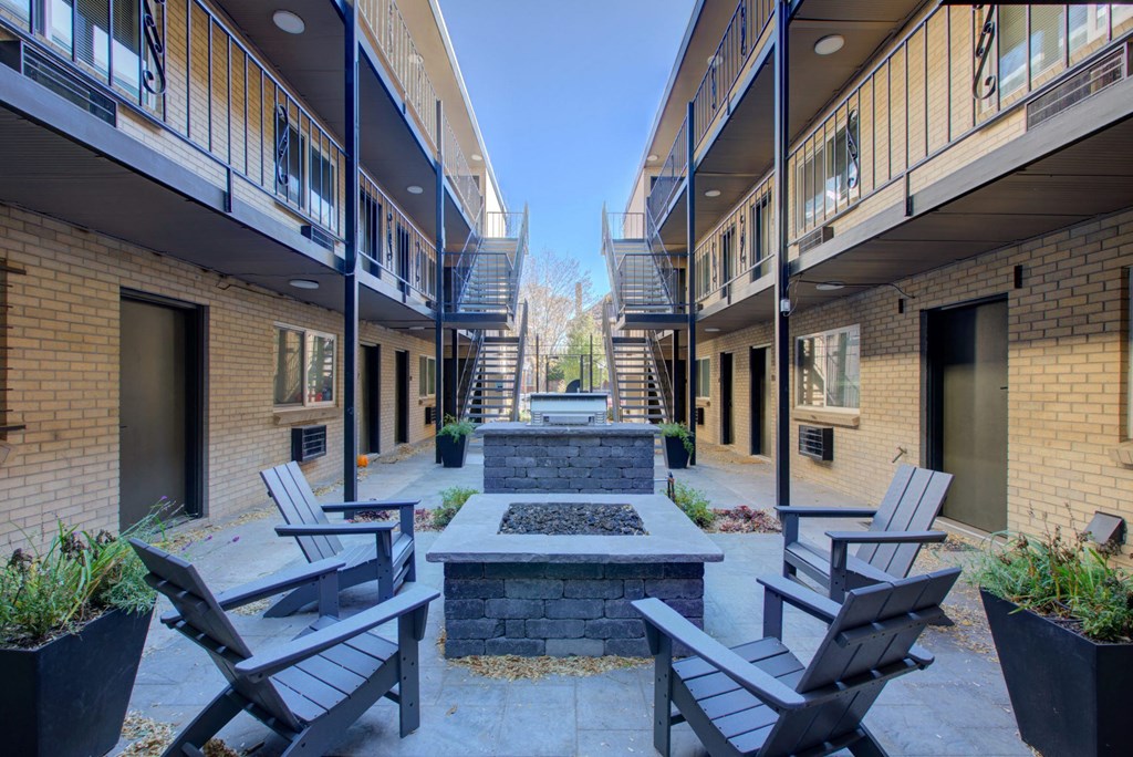a courtyard with a fountain and chairs at the bradley braddock road station apartments