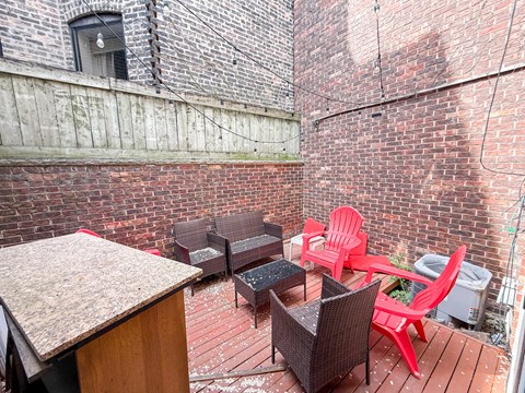 A patio with a table and chairs.