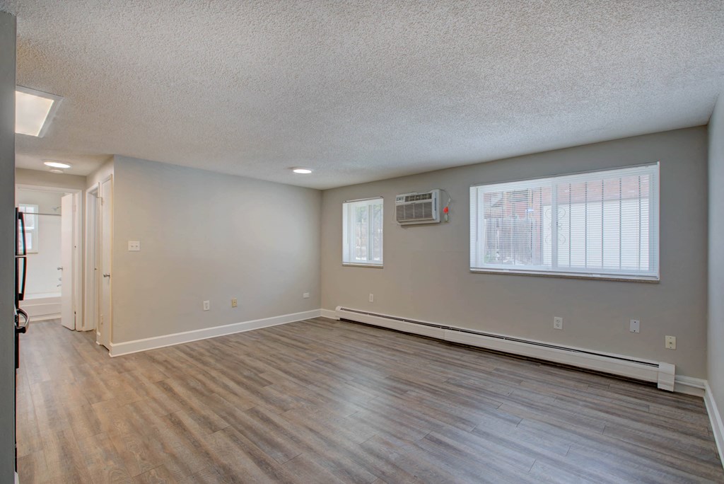 the living room and dining room of an empty house