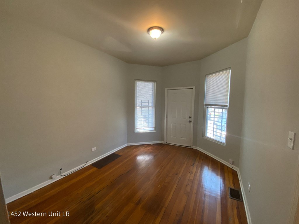 a look at the living room with hardwood floors and two windows