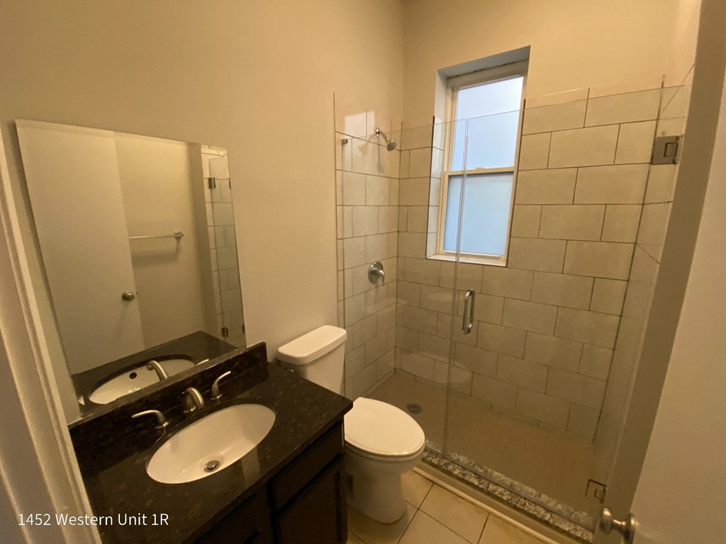 a bathroom with a shower toilet and sink