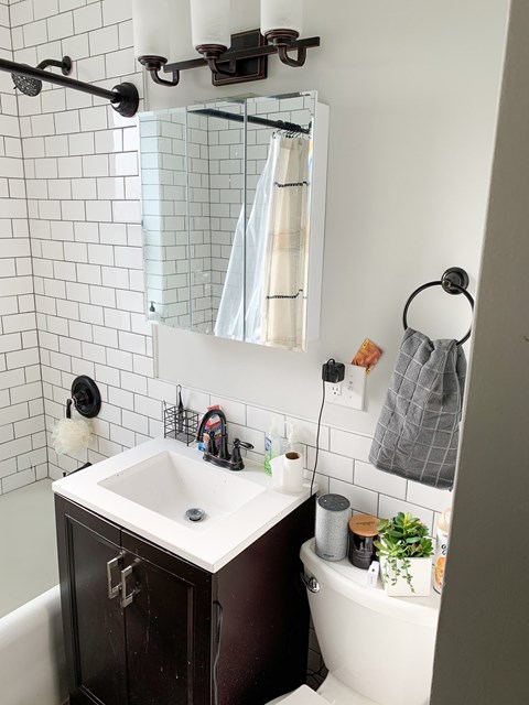 A bathroom with a white sink and a white tub.