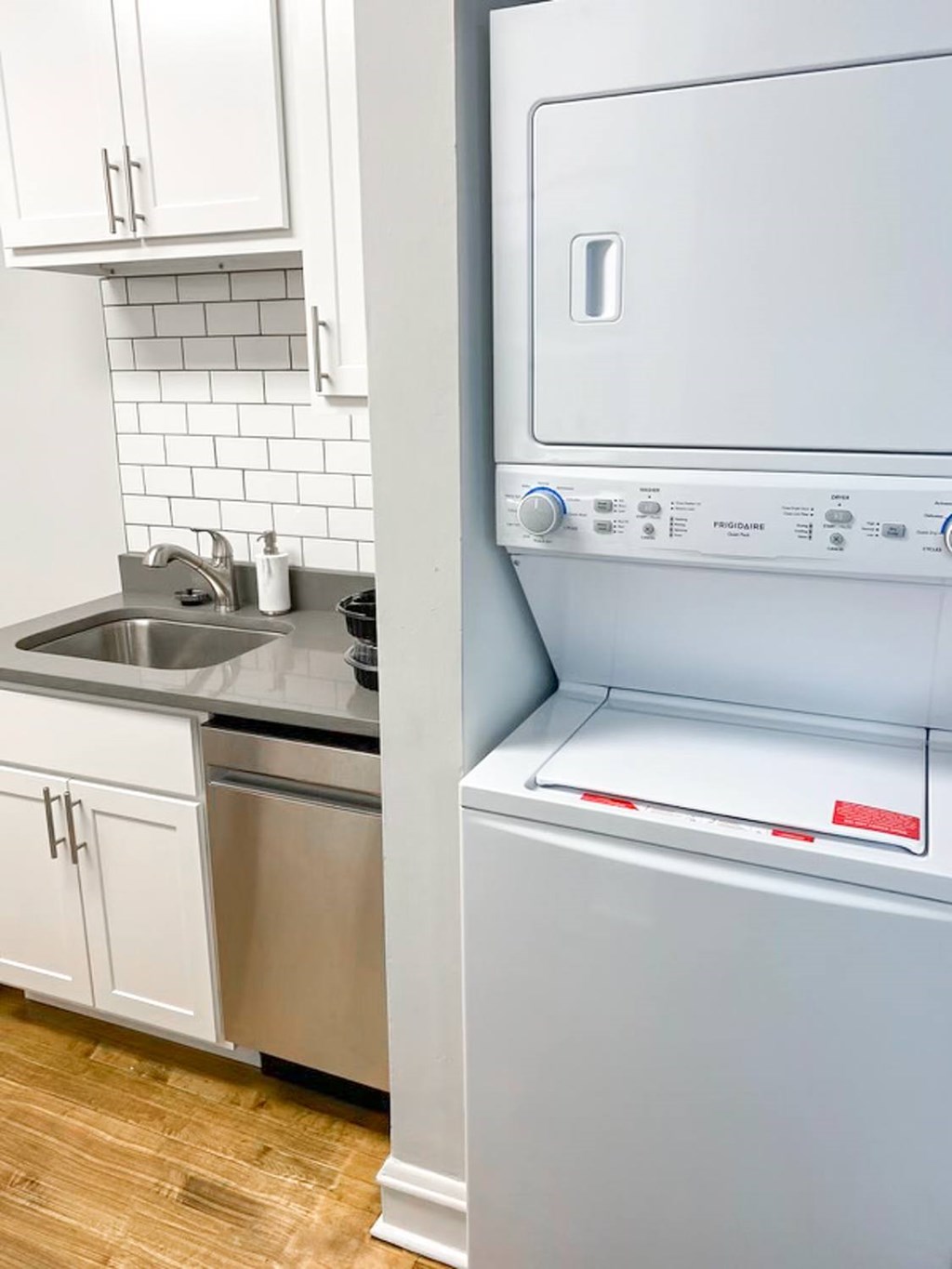 A white dishwasher is next to a white oven in a kitchen.
