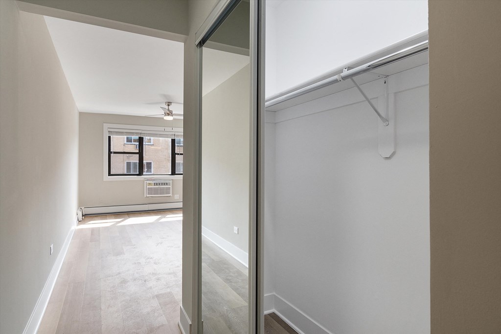 a bedroom with a medium sized closet and a ceiling fan