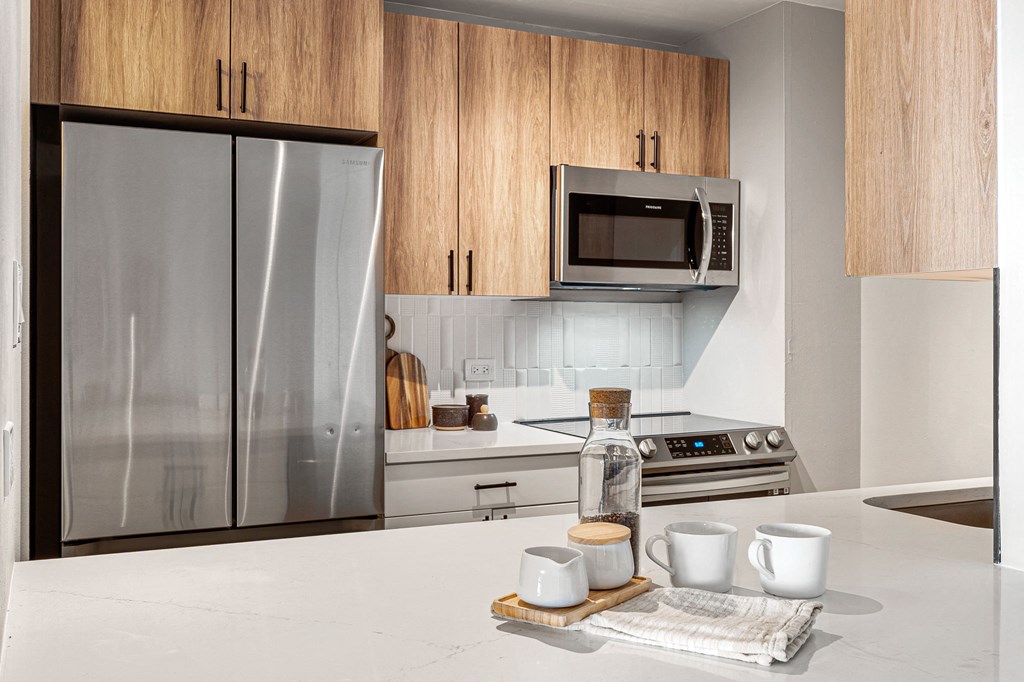 modern kitchen with stainless steel appliances and wooden cabinets