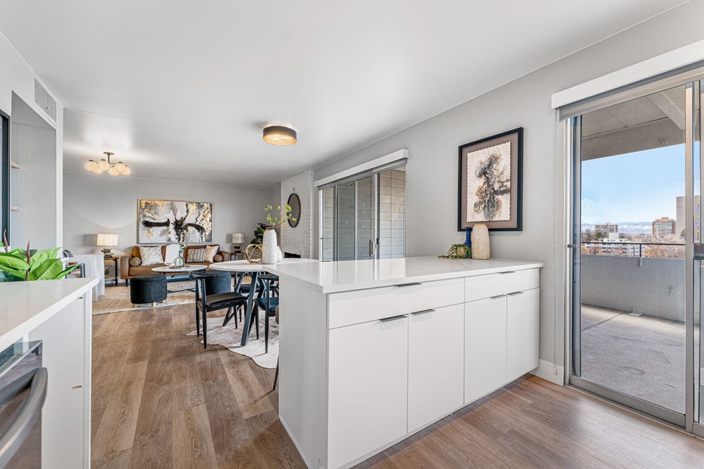 a kitchen with a white counter top and a sliding glass door