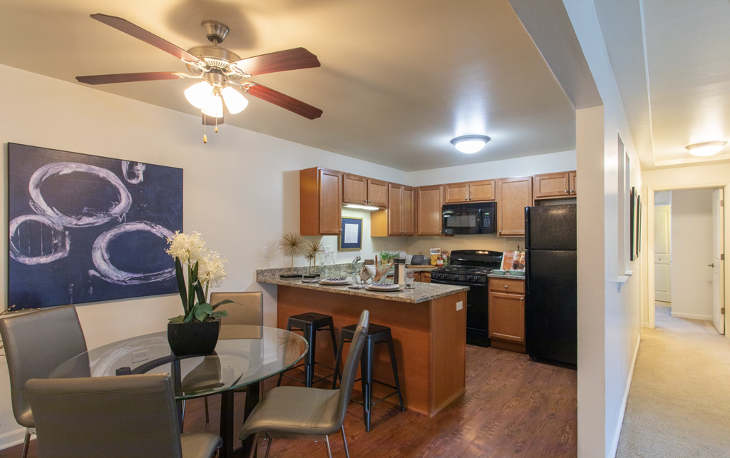 an open kitchen and dining area with a glass table and chairs