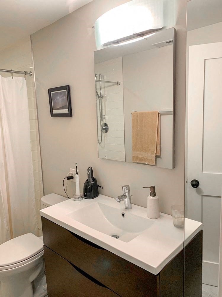 a bathroom with a white sink and a mirror