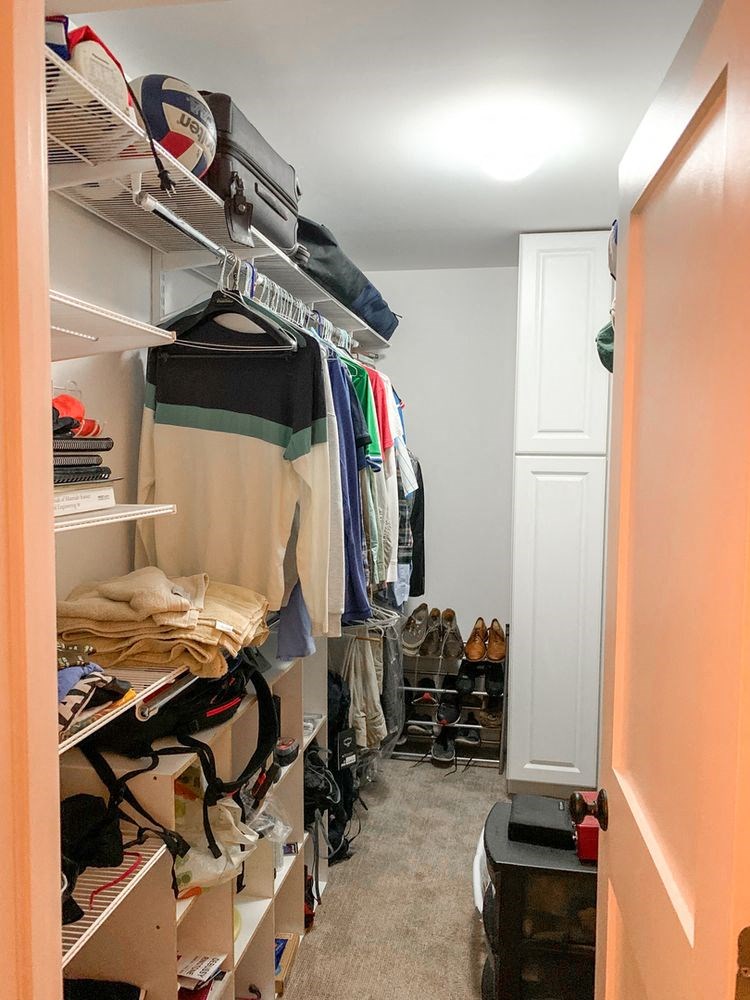 a walk in closet with a lot of clothes in it
