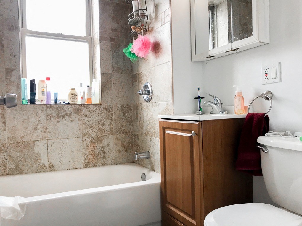 a bathroom with a toilet and a tub and a sink