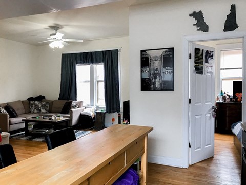a living room and dining room with a wooden table