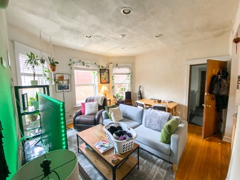 A living room with a grey couch and a wooden coffee table.