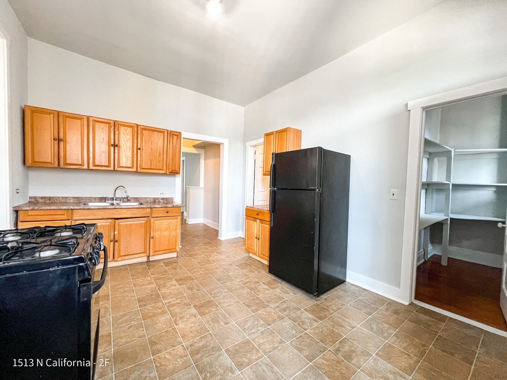 a kitchen with black appliances and wooden cabinets