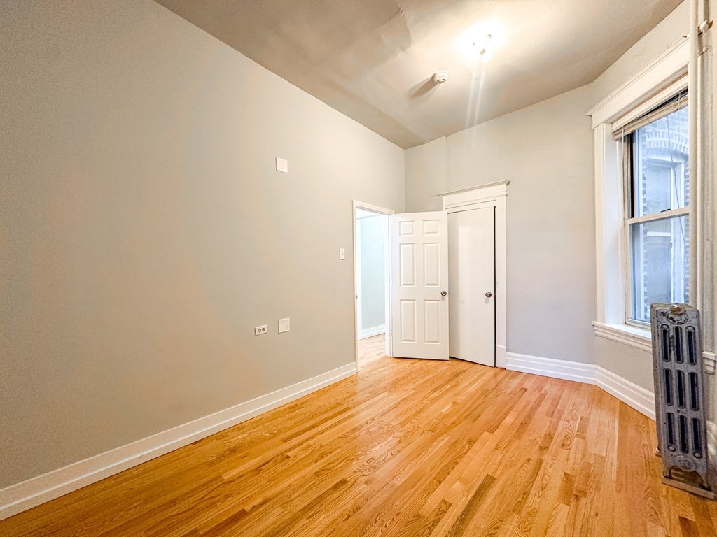 A room with wooden floors and white walls.
