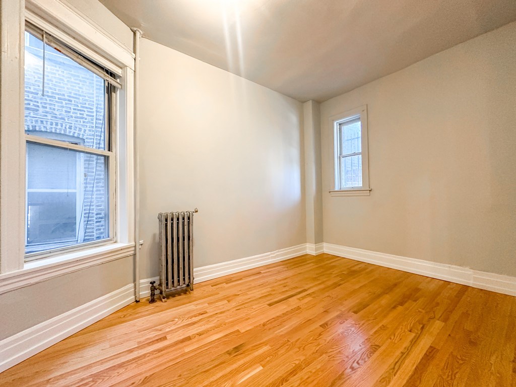A room with wooden floors and a window.