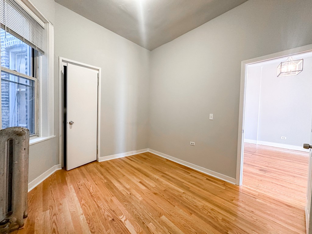 A room with wooden floors and white walls.