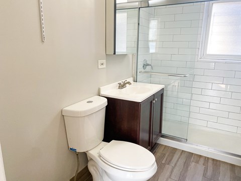 A white toilet sits next to a sink in a bathroom.