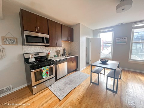 A kitchen with a stove top oven and microwave.