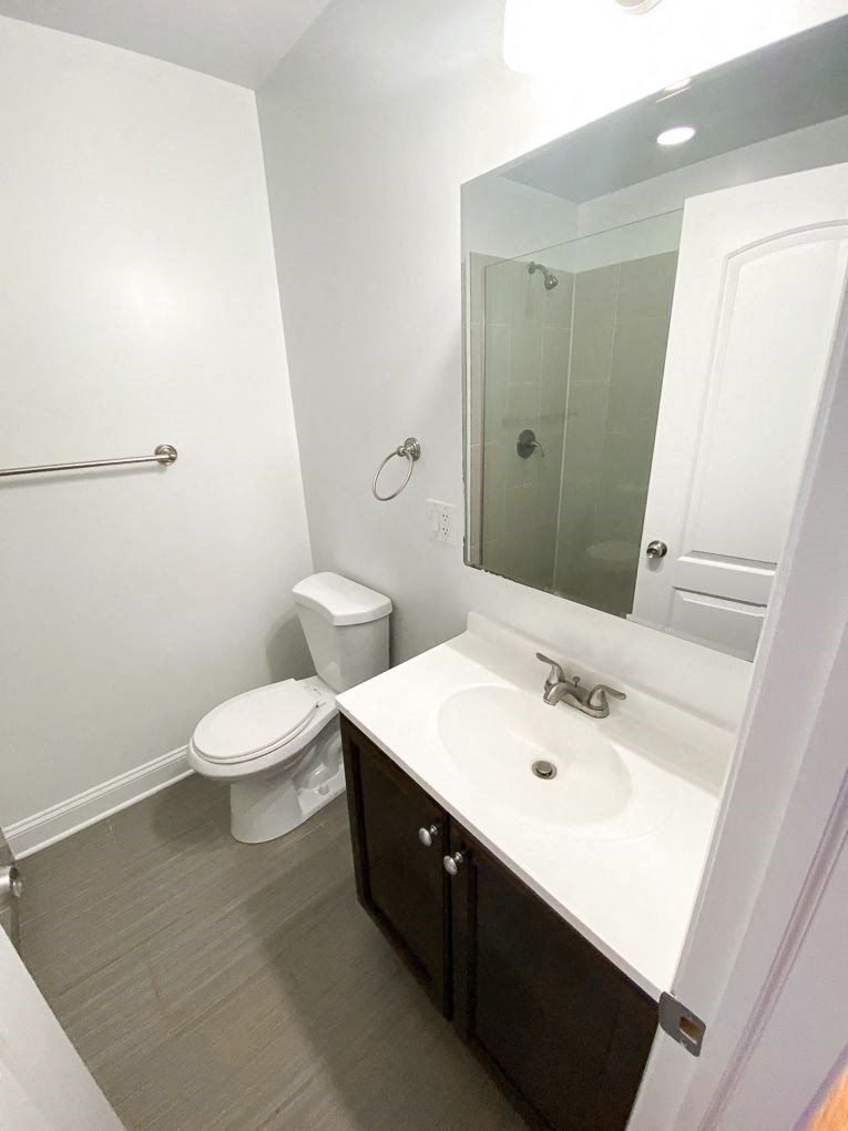 a bathroom with a sink toilet and a mirror