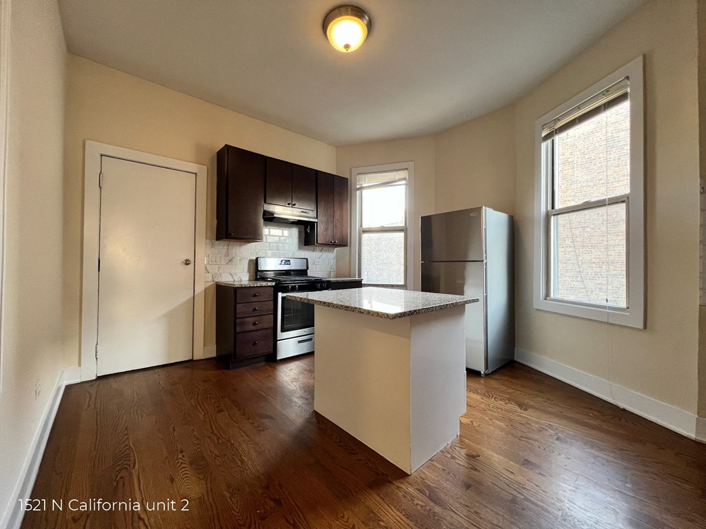 an empty kitchen with an island in the middle