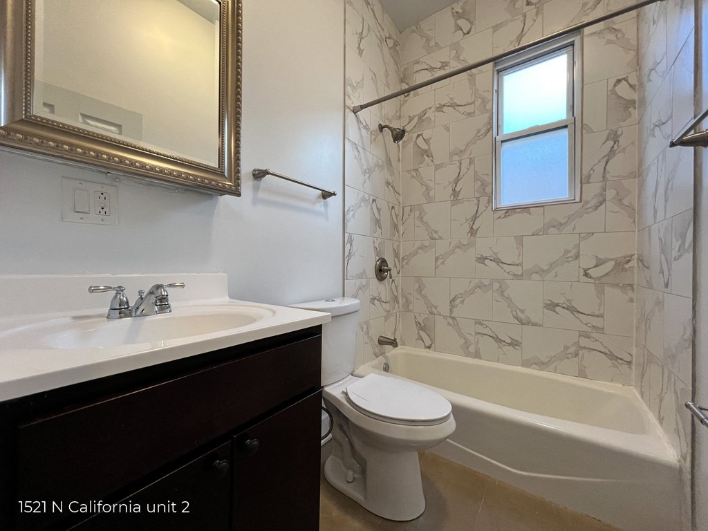 a bathroom with a sink toilet and a bath tub