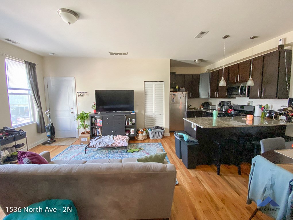 a view of the living room and kitchen of an apartment
