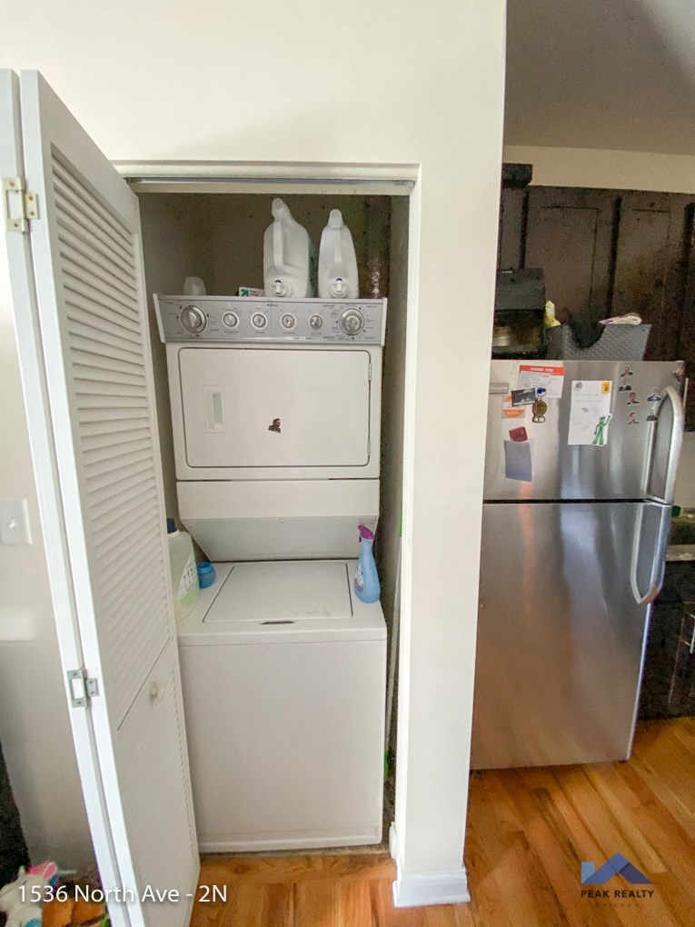 the laundry room has a washer and dryer and a refrigerator