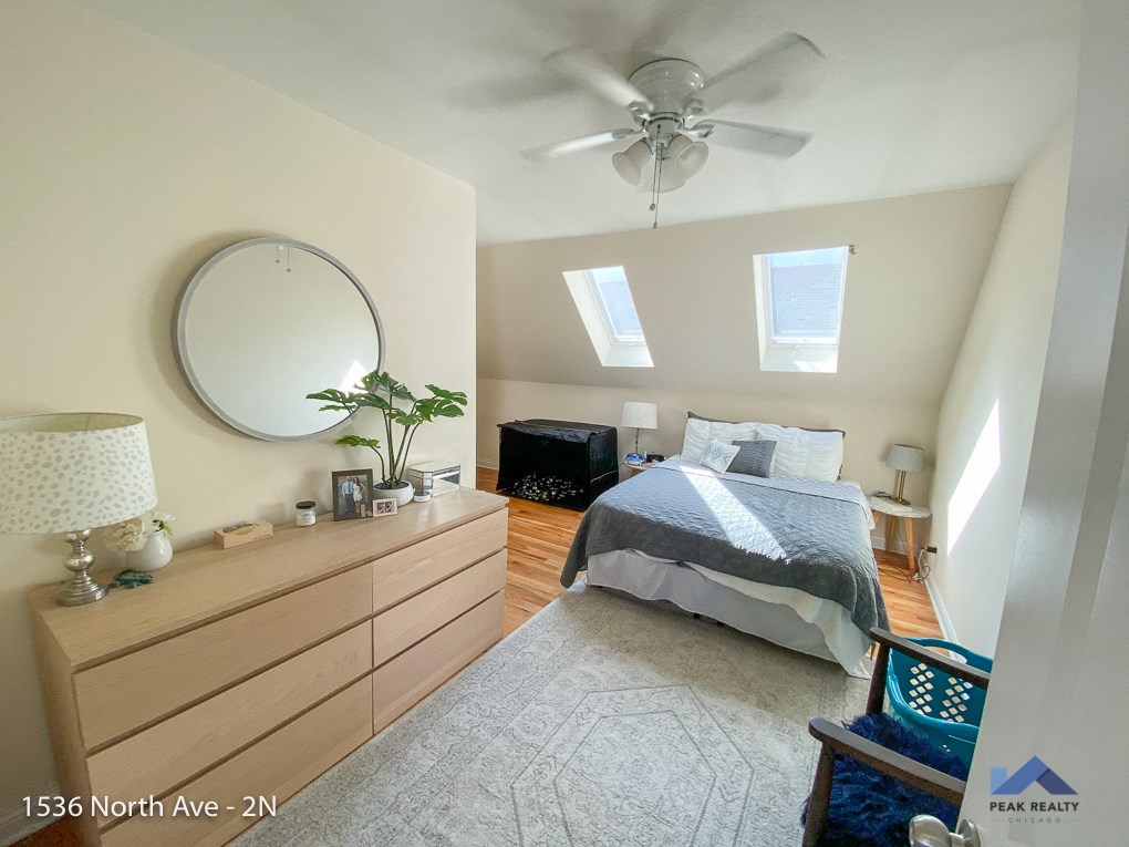 a bedroom with a bed and a ceiling fan