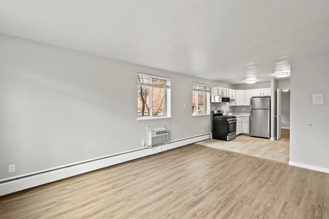 A kitchen area with a refrigerator, oven, and a dishwasher.