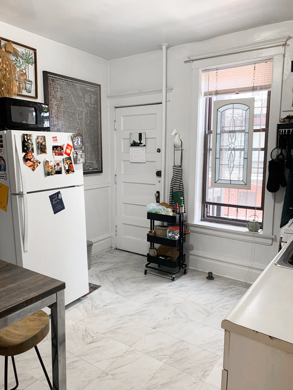 a small kitchen with a refrigerator and a window