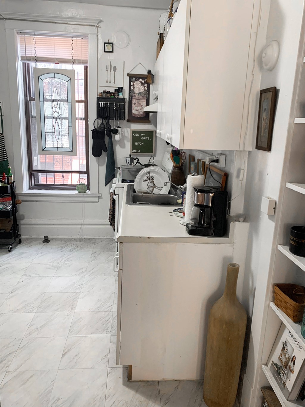 a small kitchen with a sink and a window