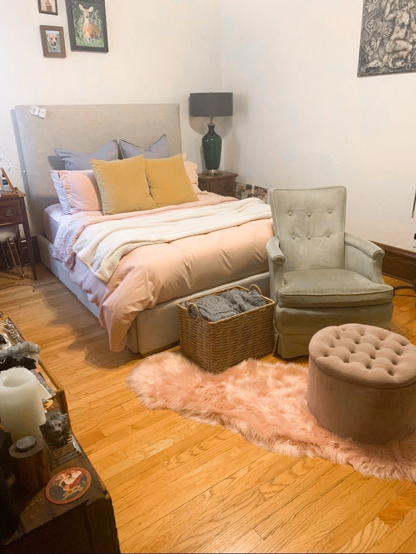 a bedroom with a bed and a chair and a rug