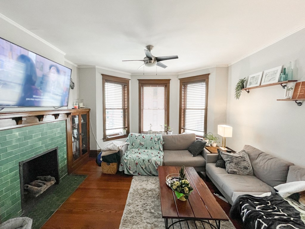 A living room with a fireplace and a television.