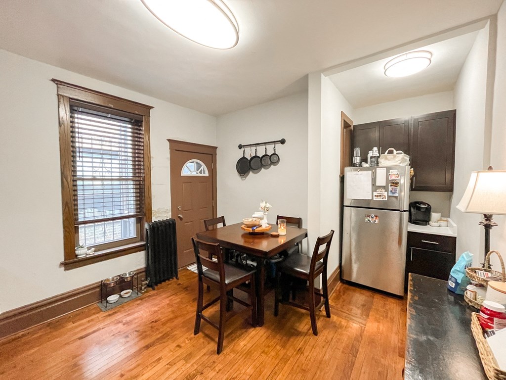 A kitchen with a table and chairs in the middle of the room.