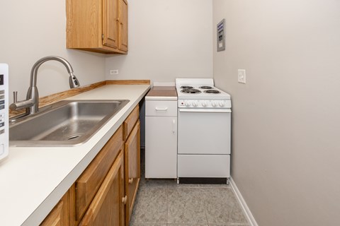 A small kitchen with a white dishwasher and a white stove.