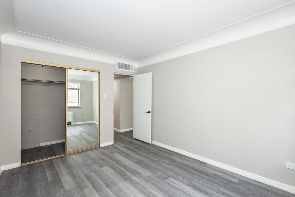 a bedroom with grey walls and a white ceiling