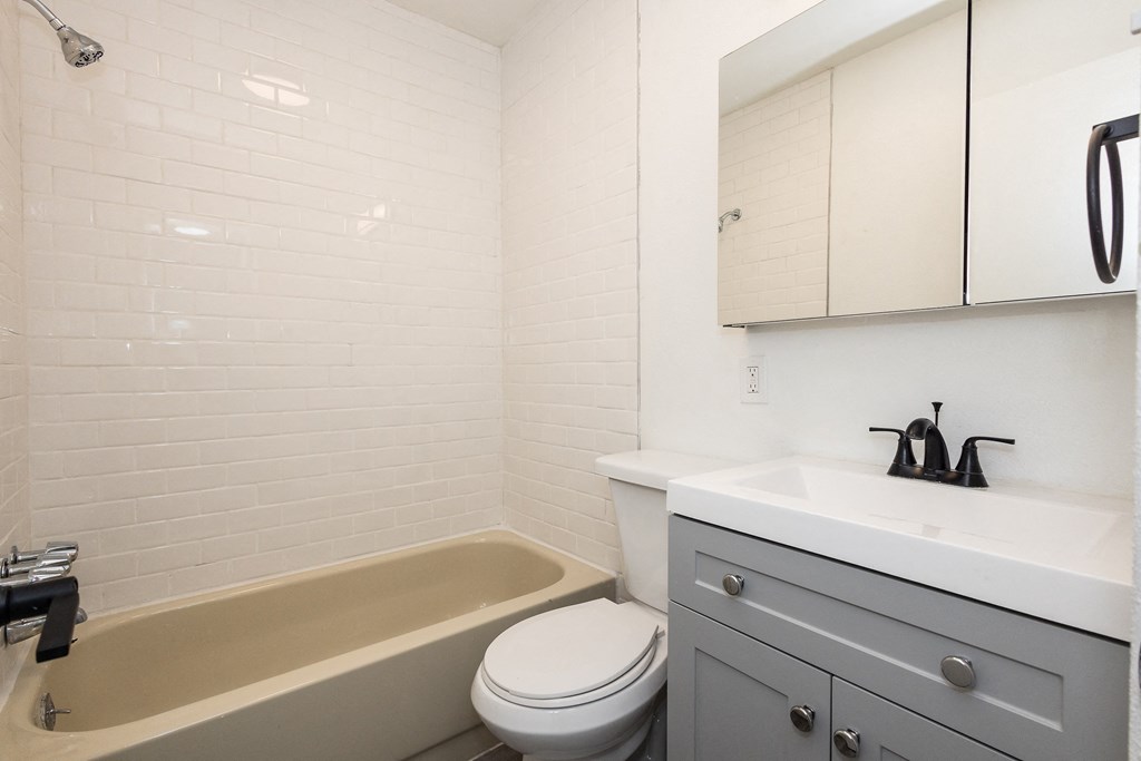 a bathroom with a sink toilet and bathtub