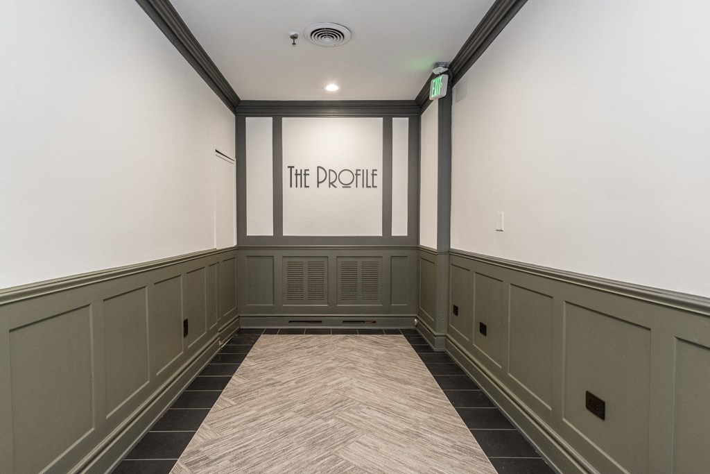 an empty room with a large window and a sign on the wall that says the profile