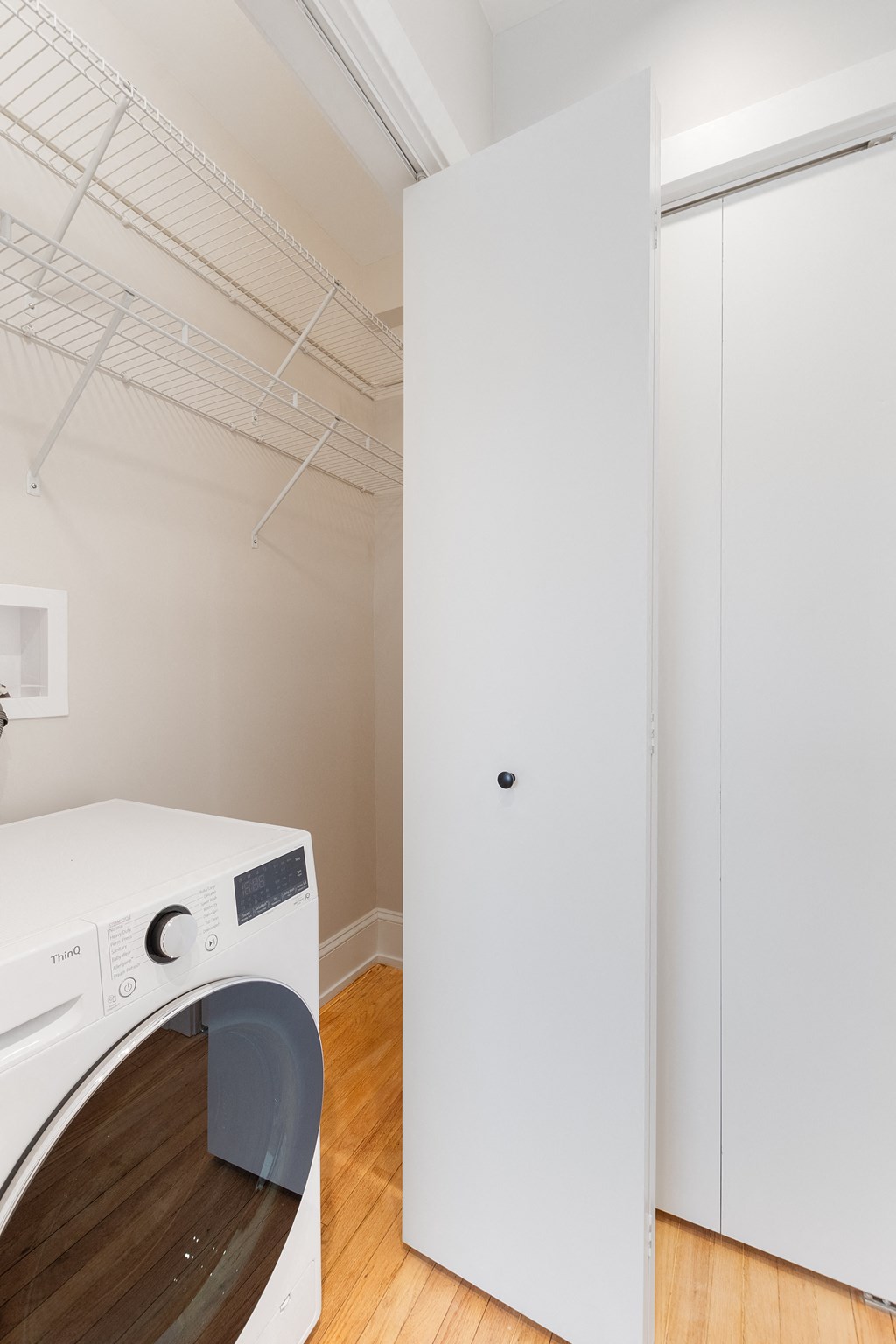 a laundry room with a washer and dryer and a white closet