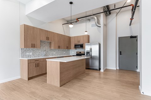 A kitchen with wooden cabinets and a granite countertop.