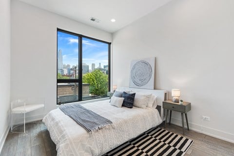 A bedroom with a large bed and a large window