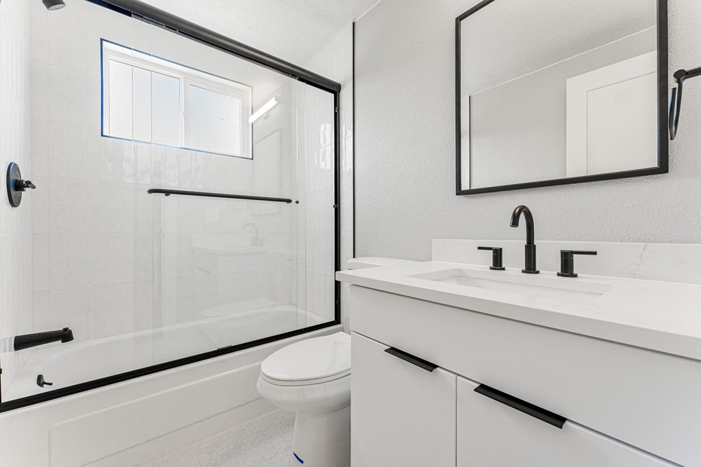 a bathroom with a toilet sink and shower