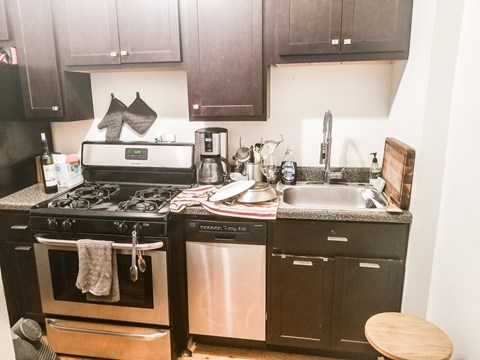A kitchen with a black oven and a black dishwasher.
