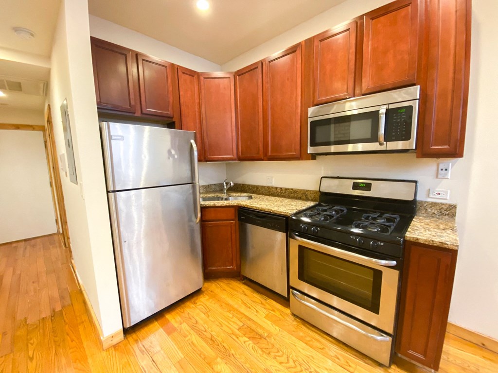 a kitchen with stainless steel appliances and wooden cabinets