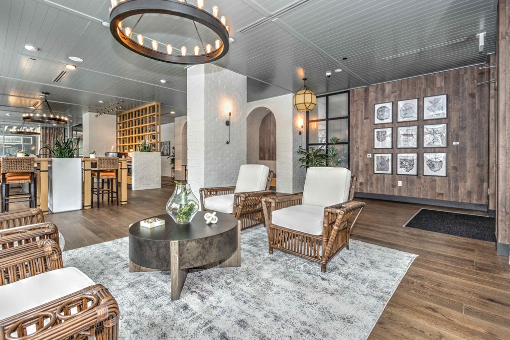 a living room with chairs and a table