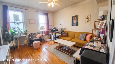 a living room with a yellow couch and a dining room table